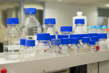 laboratory equipment pipette dropping sample into a test tube,abstract science background.