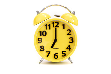 Yellow alarm clock on white at 7 o'clock