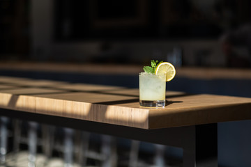 Cocktail with lemon on bar