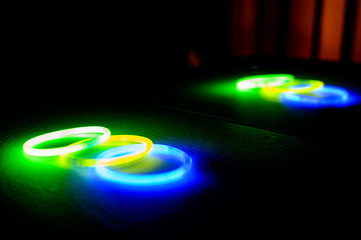 Neon glow stick bracelets in a pile