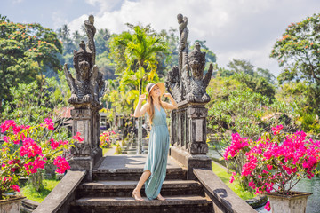 Young woman tourist in Taman Tirtagangga, Water palace, Water park, Bali Indonesia