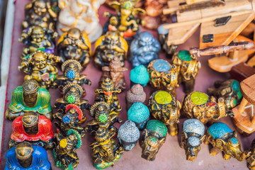 Fototapeta premium Typical souvenir shop selling souvenirs and handicrafts of Bali at the famous Ubud Market, Indonesia. Balinese market. Souvenirs of wood and crafts of local residents