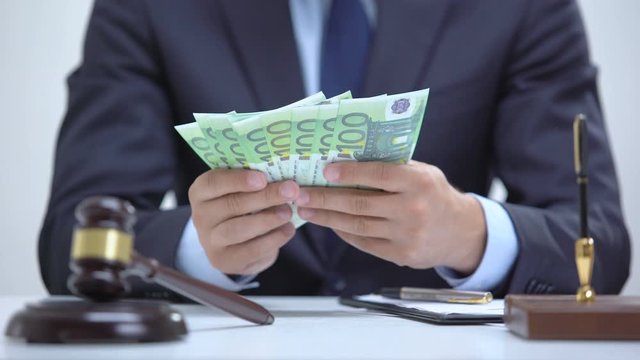 Corrupt lawyer counting euros, hiding bribe in jacket, falsifying documents
