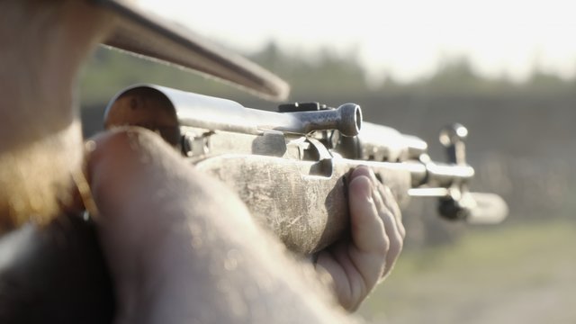 male shoots with a firearm, shotguns outdoors.