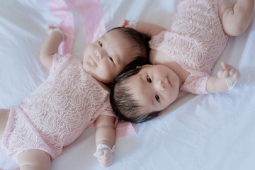 Twin babies on the bed 