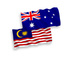 National vector fabric wave flags of Australia and Malaysia isolated on white background. 1 to 2 proportion.
