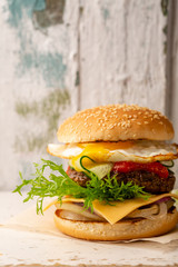 Tasty burger on white wooden table