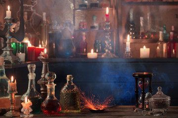 magic potions in bottles on wooden background