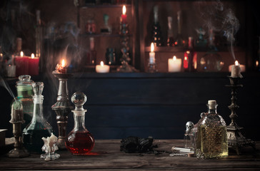 magic potions in bottles on wooden background © Maya Kruchancova