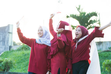 portrait of young asian muslim woman group with indonesian flag celebrate indonesian independence day