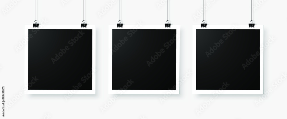Poster three empty photo frames hanging on a bulldog clip. digital snapshot image.
