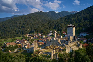 Fototapeta na wymiar Panoramic view of the Castel San Michele o Castello di Ossana region of Trento northern Italy. Castle ruins surrounded by nature in a quiet location. Aerial view.