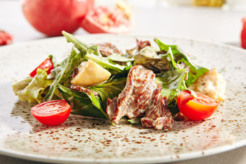 Warm salad with veal and porcini mushrooms in cream sauce