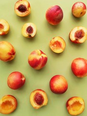Peaches on a green background flat layout top view