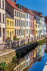 Fototapeta na wymiar Colorful houses with reflection in the canal in Wismar, Germany