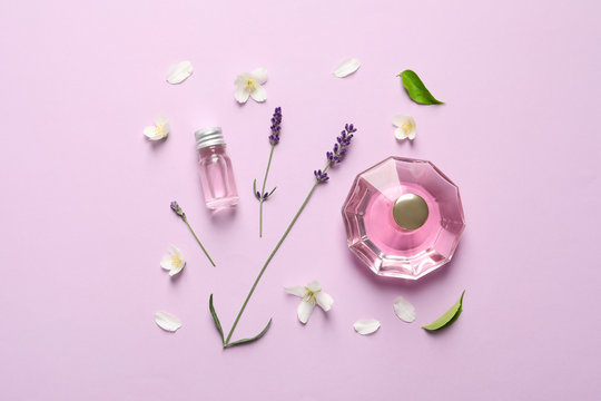 Flat lay composition with elegant perfume on lilac background
