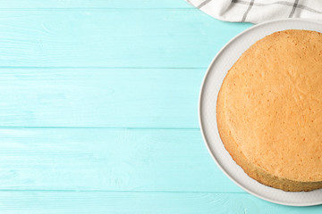 Delicious fresh homemade cake on light blue wooden table, top view. Space for text