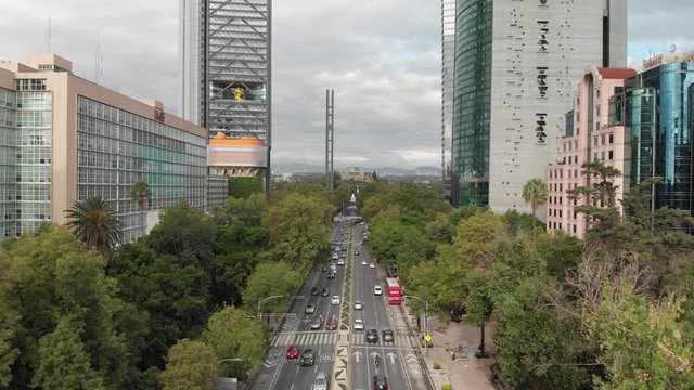 Aerial view of the traffic in Paseo de la Reforma, Mexico City during rush hour. Drone flying backwards