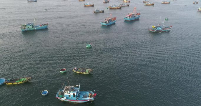 Top view. Aerial view fishing harbour market from drone. Royalty high quality free stock footage 4K of market at Mui Ne fishing harbour, fishing village. Fishing harbor is popular tourist destination