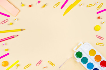 School accessories on a yellow background. Pastel colored.