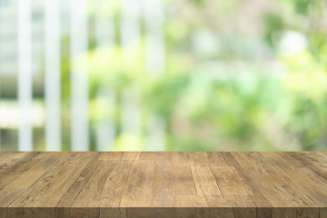 Empty wood table top on blurred background at garden in shopping mall, copy space for montage you product.