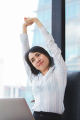 Fototapeta premium Asian business woman stretching her muscles for flexibility in the treatment of office syndrome.