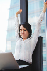 Asian business woman stretching her muscles for flexibility in the treatment of office syndrome.