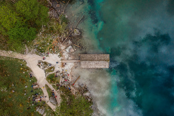 Aerial view of lake forest around. People on a picnic.