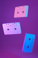 Cassette tape vintage style suspended in air on purple background