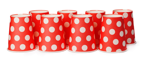 Group of cardboard disposable red dotted cups isolated