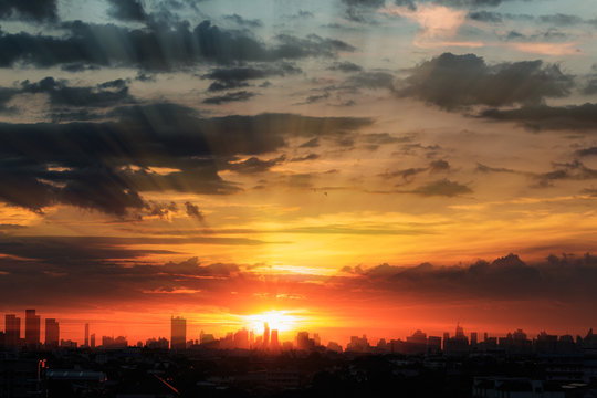 Sunset  with cityscape of building silhouette,At  twilight  in Bangkok ,Thailand