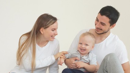 Happy young family spending time with a young son in new home.