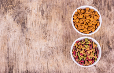 Delicious cat food. Various cat food. Cat food in white bowls. Dry pet food copy space