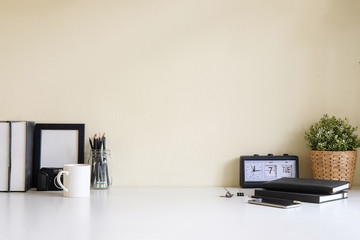 Mockup workspace desk and copy space books,plant and coffee on white desk.