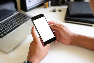 Cropped shot view of man hands holding smart phone with blank copy space screen for your text message or information content, female reading text message on cell telephone during in urban setting. 