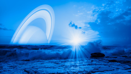 Amazing sunset on the stormy sea with Saturn planet on the skyline 
