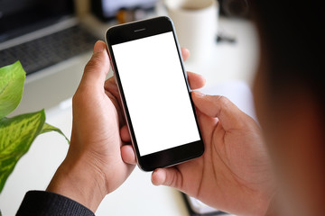Cropped shot view of man hands holding smart phone with blank copy space screen for your text message or information content, female reading text message on cell telephone during in urban setting. 