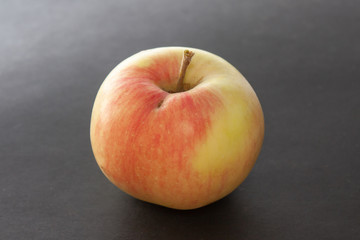 Apple plucked from a tree on a black background