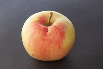 Apple plucked from a tree on a black background