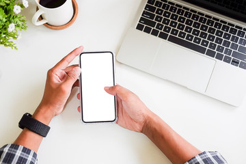 Cropped shot view of man hands holding smart phone with blank copy space screen for your text message or information content, female reading text message on cell telephone during in urban setting. 
