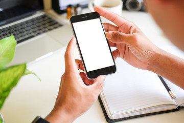 Cropped shot view of man hands holding smart phone with blank copy space screen for your text message or information content, female reading text message on cell telephone during in urban setting. 