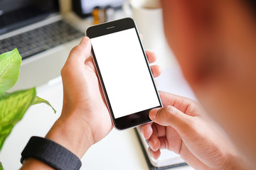Cropped shot view of man hands holding smart phone with blank copy space screen for your text message or information content, female reading text message on cell telephone during in urban setting. 