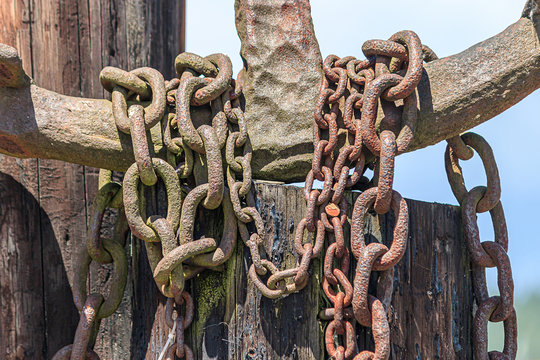 anchor and chain detail against blue sky in summer near harbor