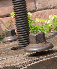 Closeup image of rusty iron bolt on an old fruit press, Vintage image