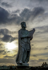 Statue against sky at sunset