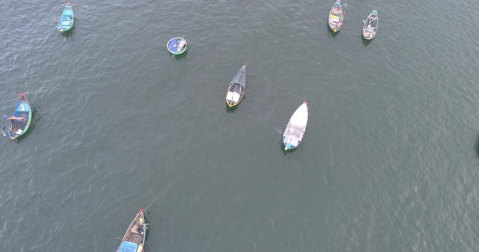 Top view, aerial view fishing harbor market from a drone. Royalty high-quality free stock video footage of market at Mui Ne fishing harbour or fishing village. Fishing harbor is a popular tourist