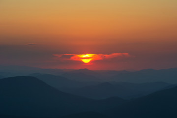 Fantastic starry night with galaxy Milky Way with a tourist and a tent on the mountain range in the Ukrainian Carpathians	