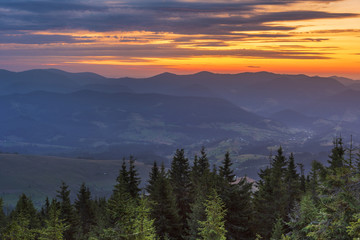 Fantastic starry night with galaxy Milky Way with a tourist and a tent on the mountain range in the Ukrainian Carpathians	