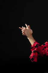 Close-up flamenca holding hands on black background - obrazy, fototapety, plakaty