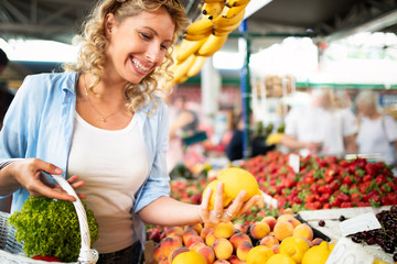 Young woman shopping healthy food on the market